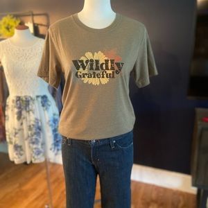Bella Canvas Brand T-shirt in Dark Khaki. Features a “ Wildly Grateful “ graphic
